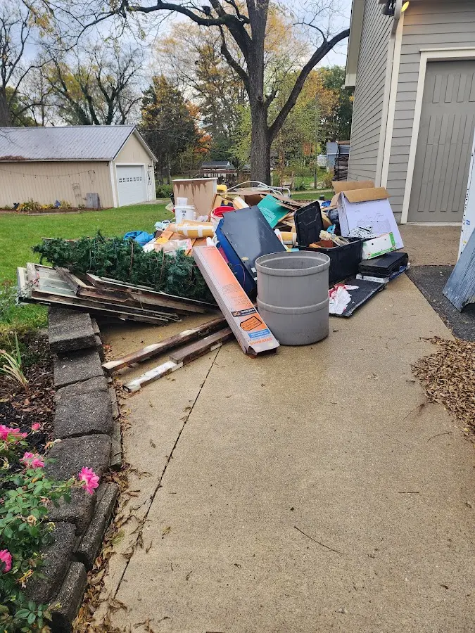 Dumpster being loaded with debris for Roofing Dumpster Rental in Waynesville